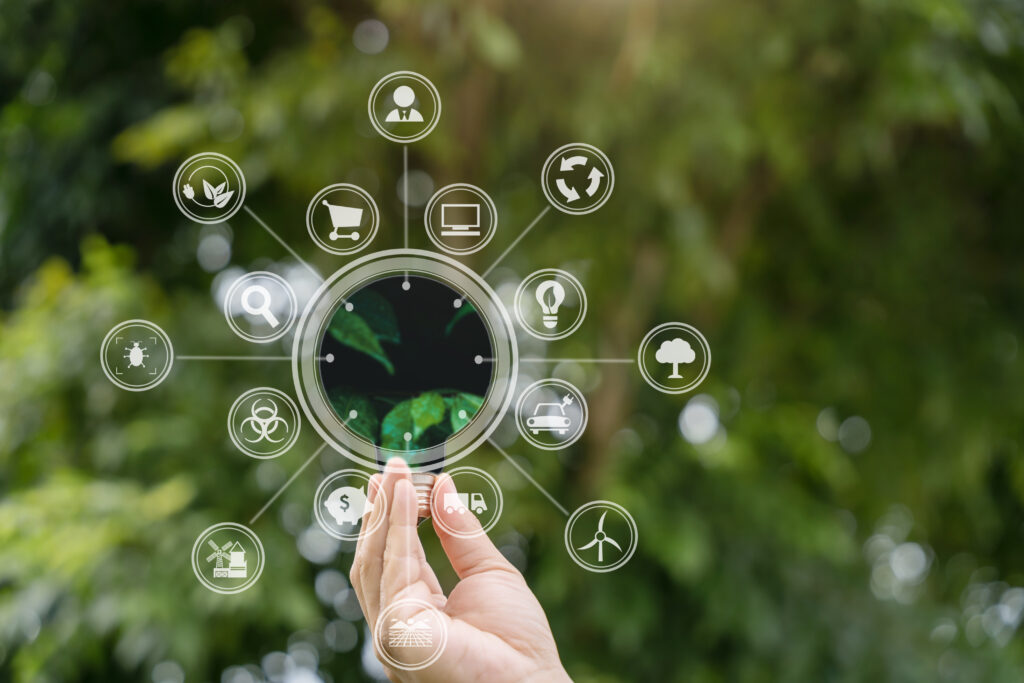 light bulb against nature, icons, green background for energy co